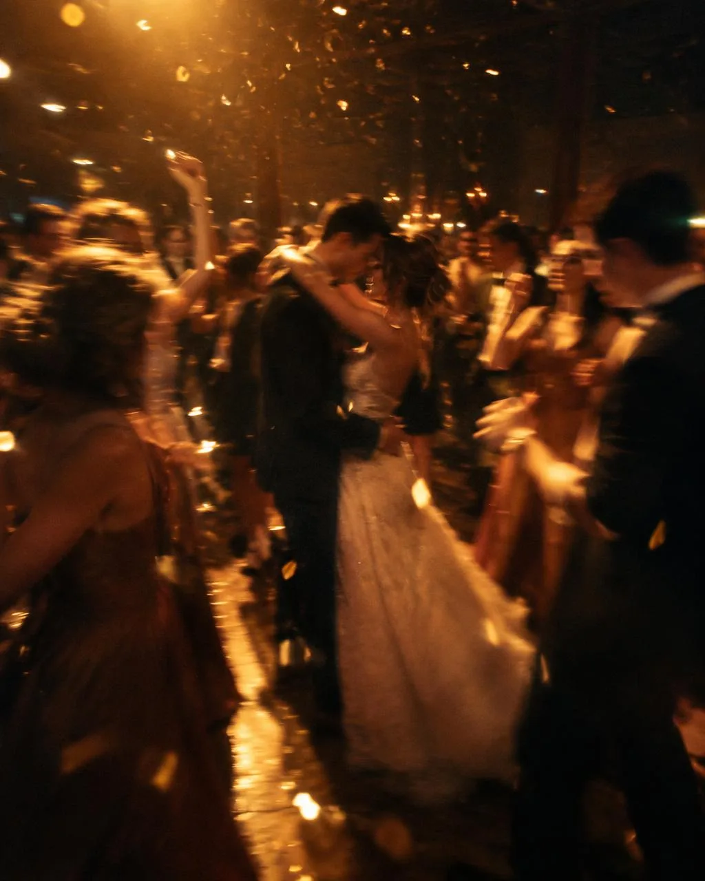 Guests dancing around a newly married couple on a wedding dance floor